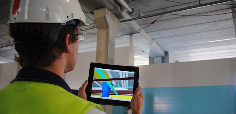 Tablettitietokoneella rakennuksen todellisuutta voi verrata 3D-malliin, kuten tässä tehdään Kauppakeskus Puuvillan työmaalla Porissa. 